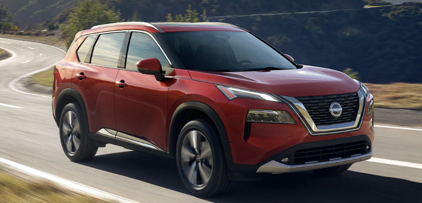 2023 red nissan rogue driving down highway
